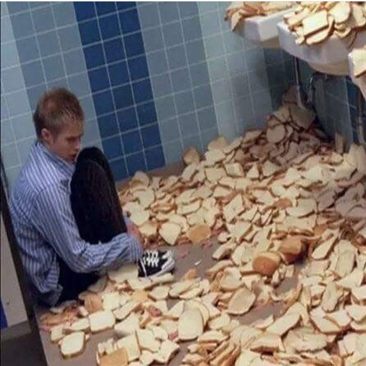 Person surrounded by scattered bread slices
