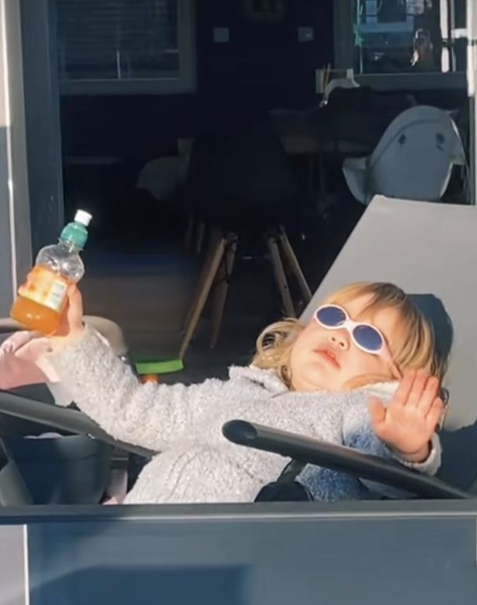 Child relaxing with sunglasses and drink